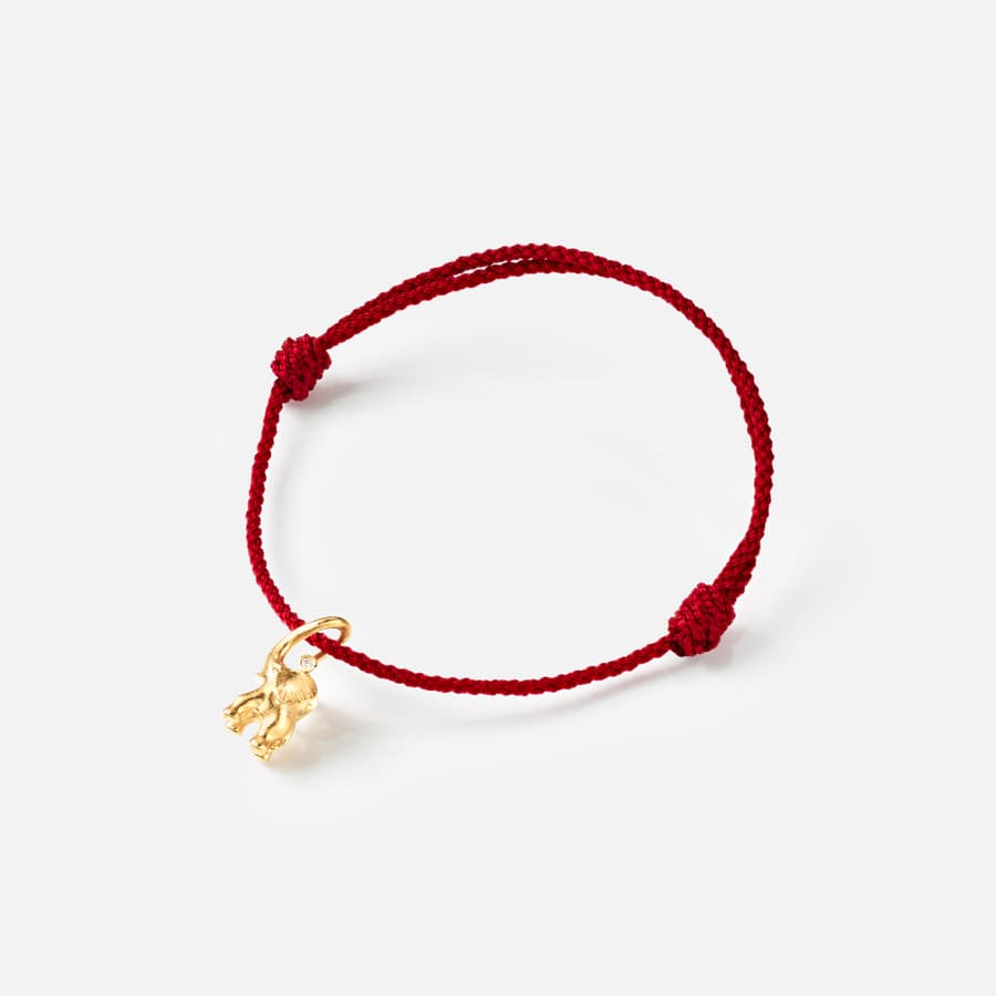 Elephant string bracelet in yellow gold with a diamond on red nylon string | Ole Lynggaard